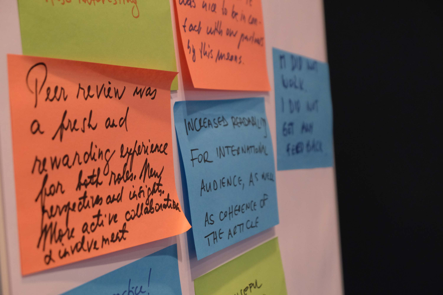 Several sticky notes on a white board