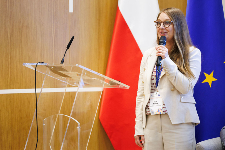 A woman speaking from a podium